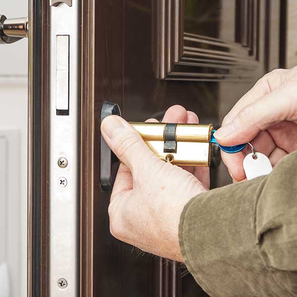 Locksmith replacing a cylinder lock